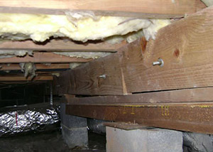 sagging crawl space with wooden shimming a Methuen crawl space