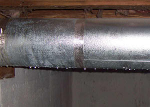 condensation collecting on an HVAC vent in a humid Revere basement