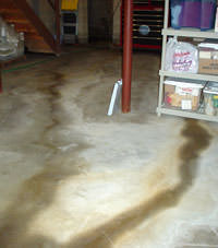 Flooding entering a basement through a floor crack in Woburn
