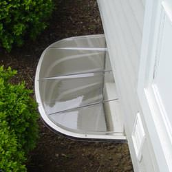 A vinyl basement window and covered window well in Gloucester