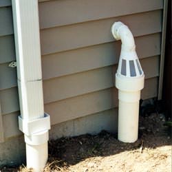 A grated sump pump discharge line fitting in Natick