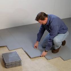 basement subfloor tiles being installed by a contractor in Lexington
