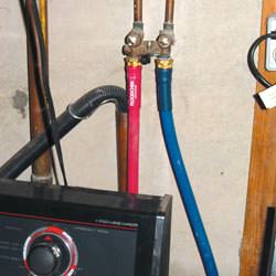Washer hoses in a basement  in North Andover