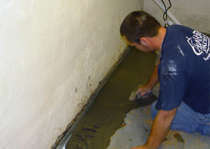 Restoring a concrete slab floor with fresh concrete after jackhammering it and installing a drain system in Lexington.