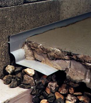 a custom designed basement drain system for thin basement floors in Andover.