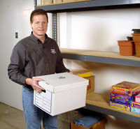 A Basement Systems waterproofer installing a basement drain for a dry space