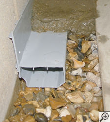 A no-clog basement french drain system installed in Waltham