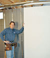 Installing wall panels on top of our basement wall insulation in Framingham