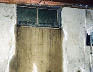 Water pouring out from a basement window in Somerville